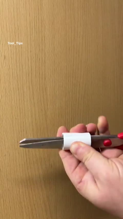 This high-detail, close-up photograph captures a powerful electric drill in action, boring a hole into a light grey cinder block or concrete wall. The focus is sharp on the drill bit as it penetrates the textured surface, highlighting the rugged nature of masonry work and home improvement projects. The image illustrates the precision and force required for structural repairs, installations, and various DIY construction tasks. The neutral grey tones of the wall provide a stark contrast to the dark body of the drill and the blue-tipped bit, making it an ideal visual for content related to building, renovation, and professional craftsmanship.