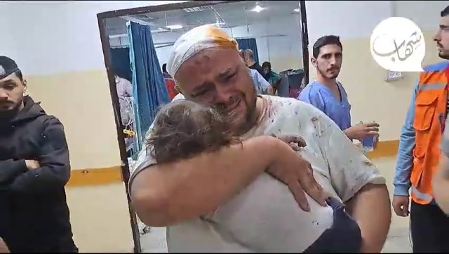 Greiving Palestine Father saying goodbye to his baby