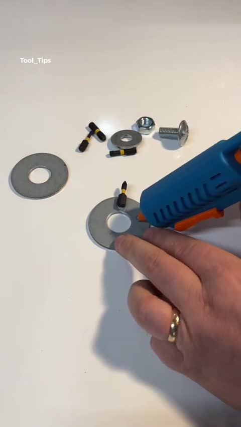 Hands Working on DIY Tool Modification with Washer and Bits